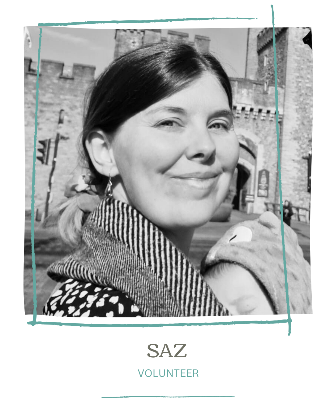 Black and white photo of a smiling woman holding a child, with a castle and street scene in the background. Text below reads "SAZ VOLUNTEER."