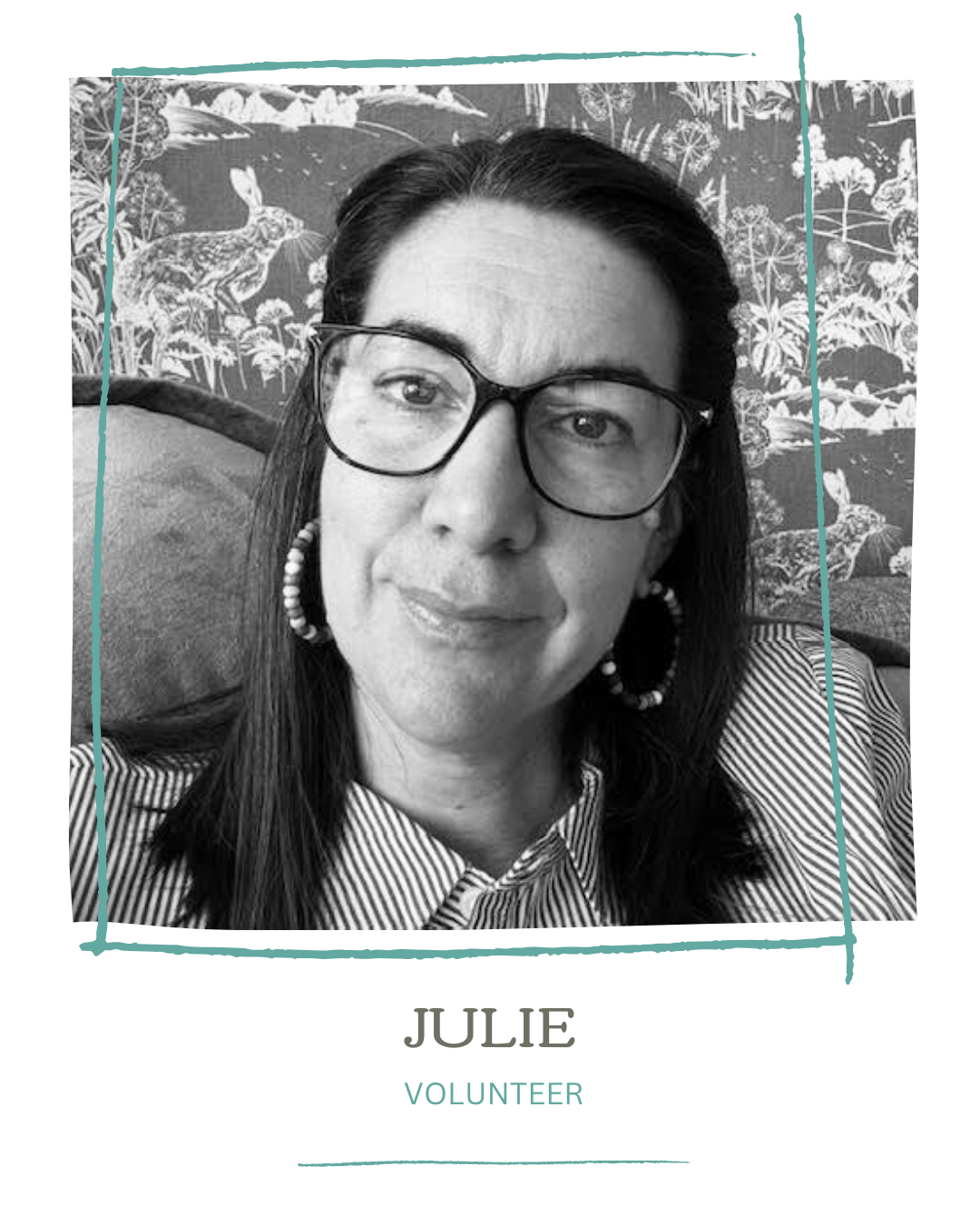 Black and white portrait of Julie, a volunteer, wearing glasses and hoop earrings, with a patterned background featuring rabbits and plants.