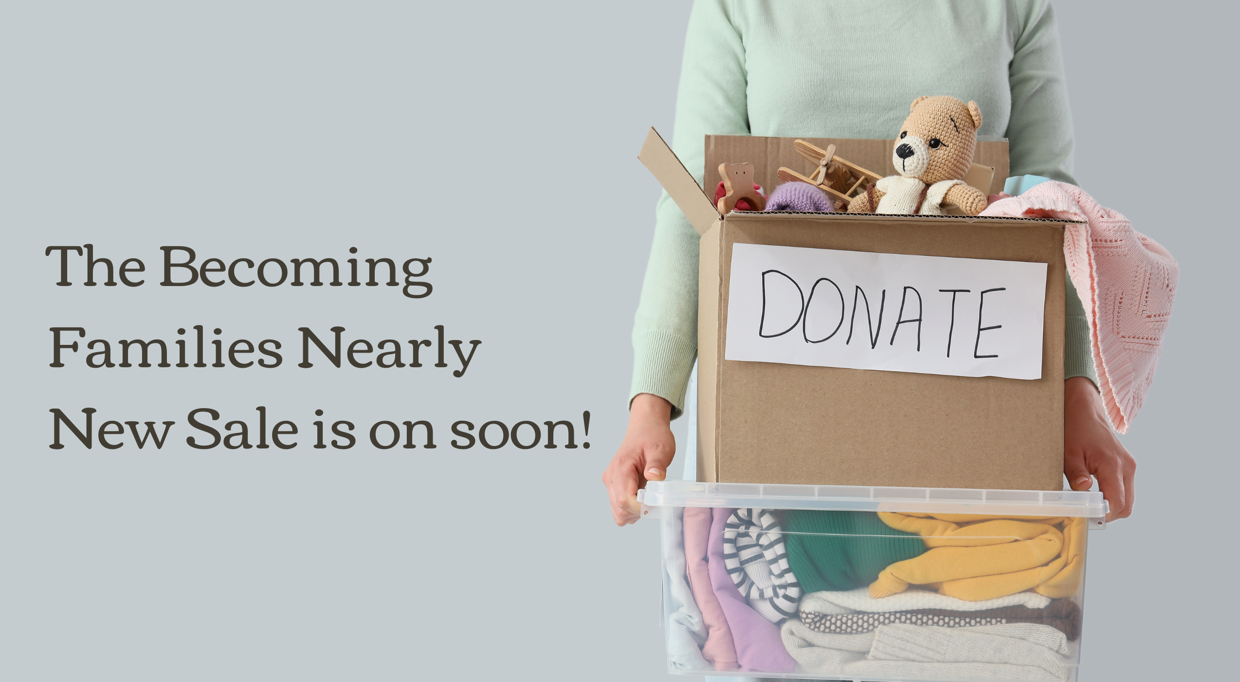 Person holding a donation box filled with clothes and toys, with a sign that says 'DONATE'