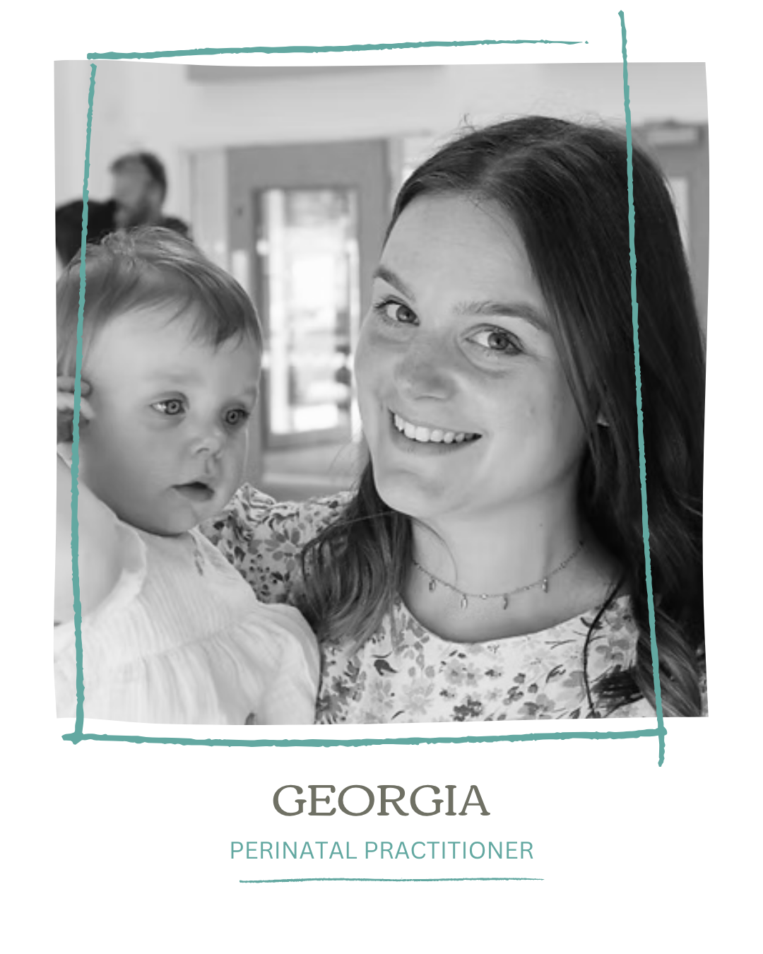Black and white photo of a smiling woman holding a young child, with a blurred background.