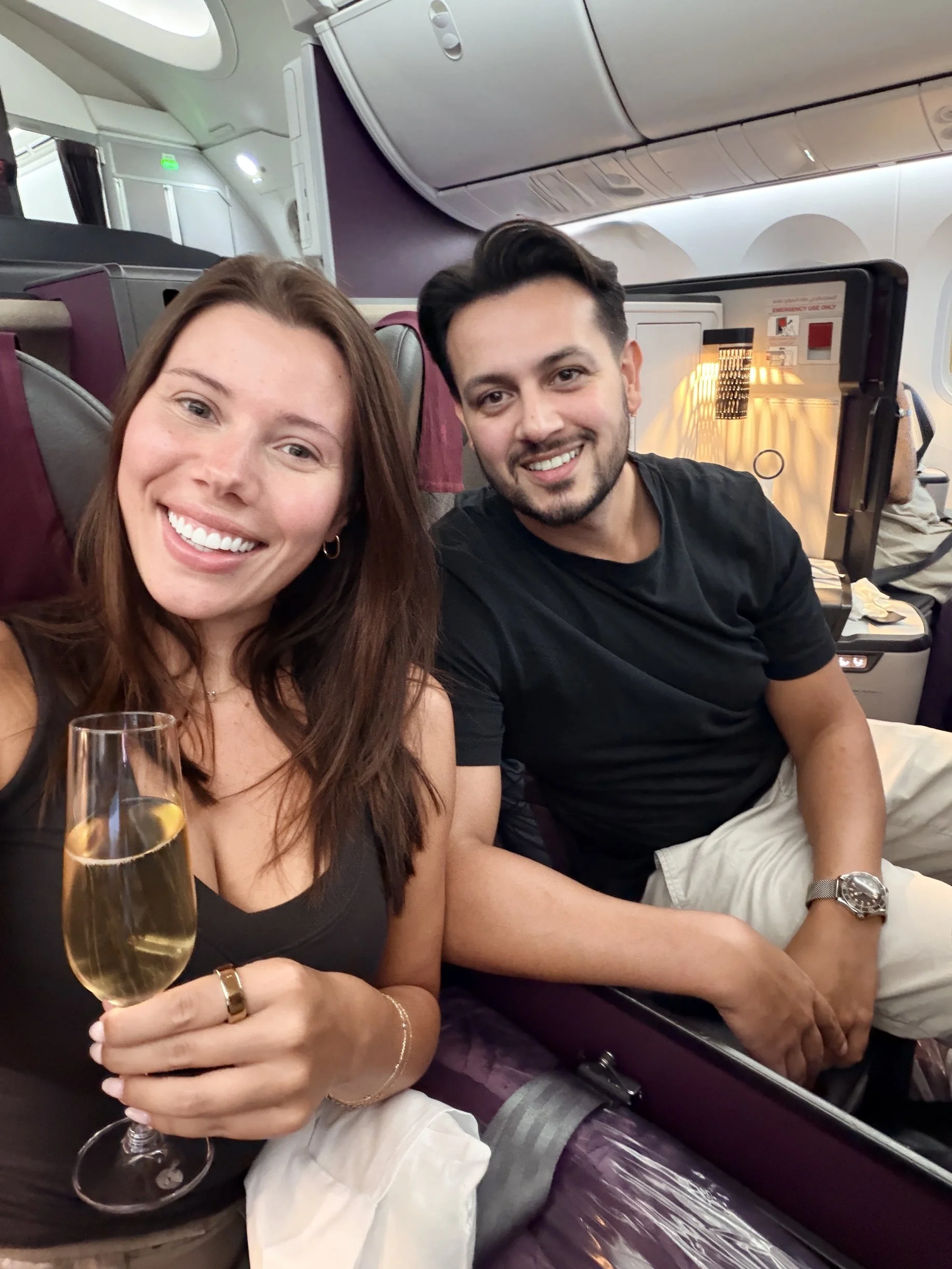 Ben and Hollie, The Airbnb Couple, smiling in a selfie on a flight