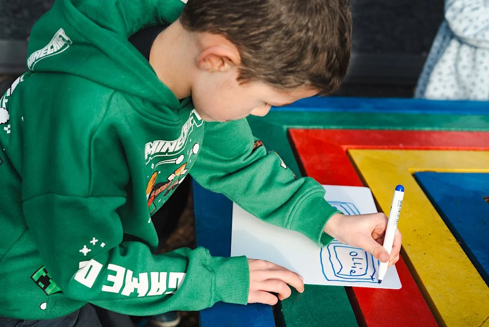 Child working outside at St Matthew's Sandymount.jpg