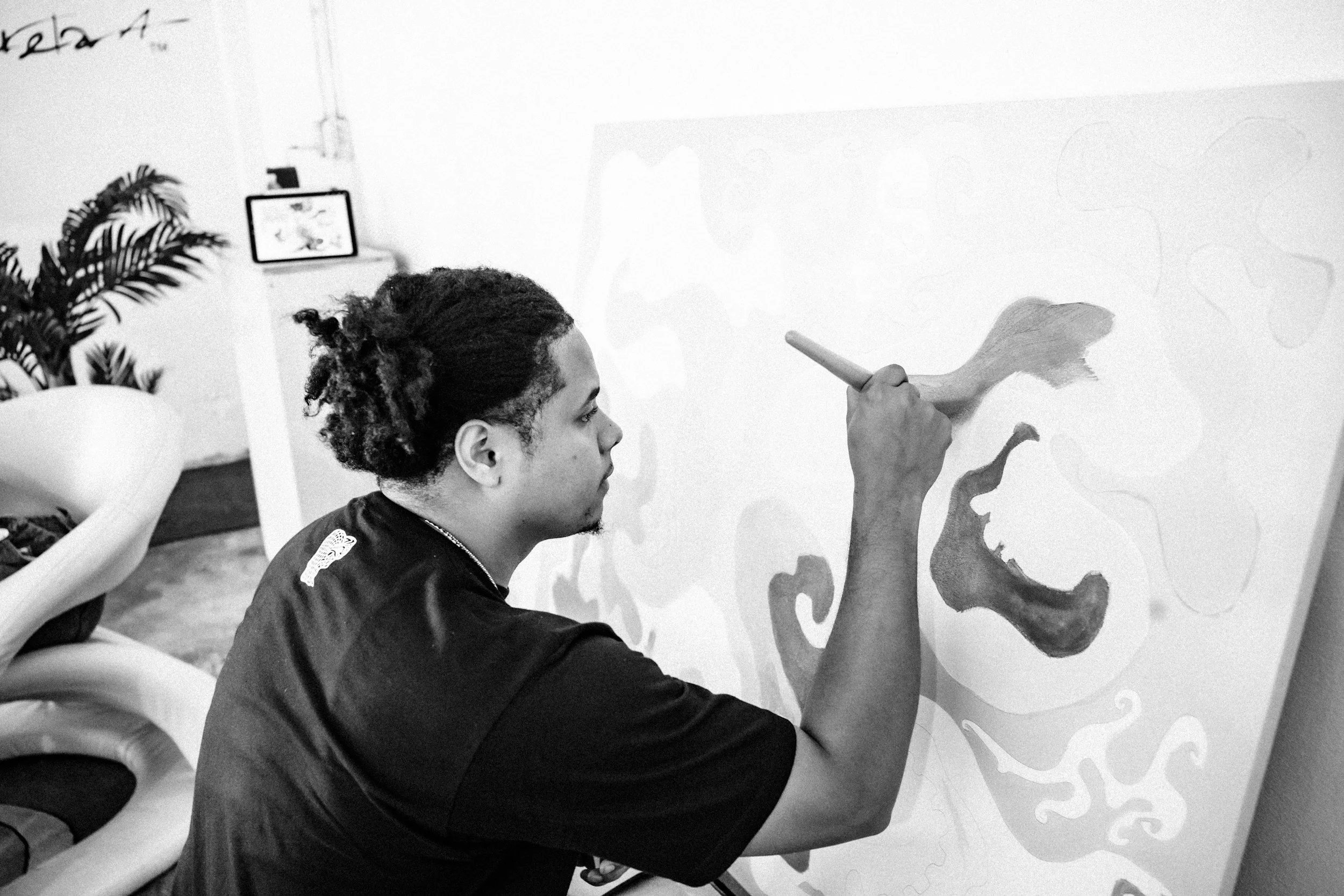 A young man is mindfully focused on painting