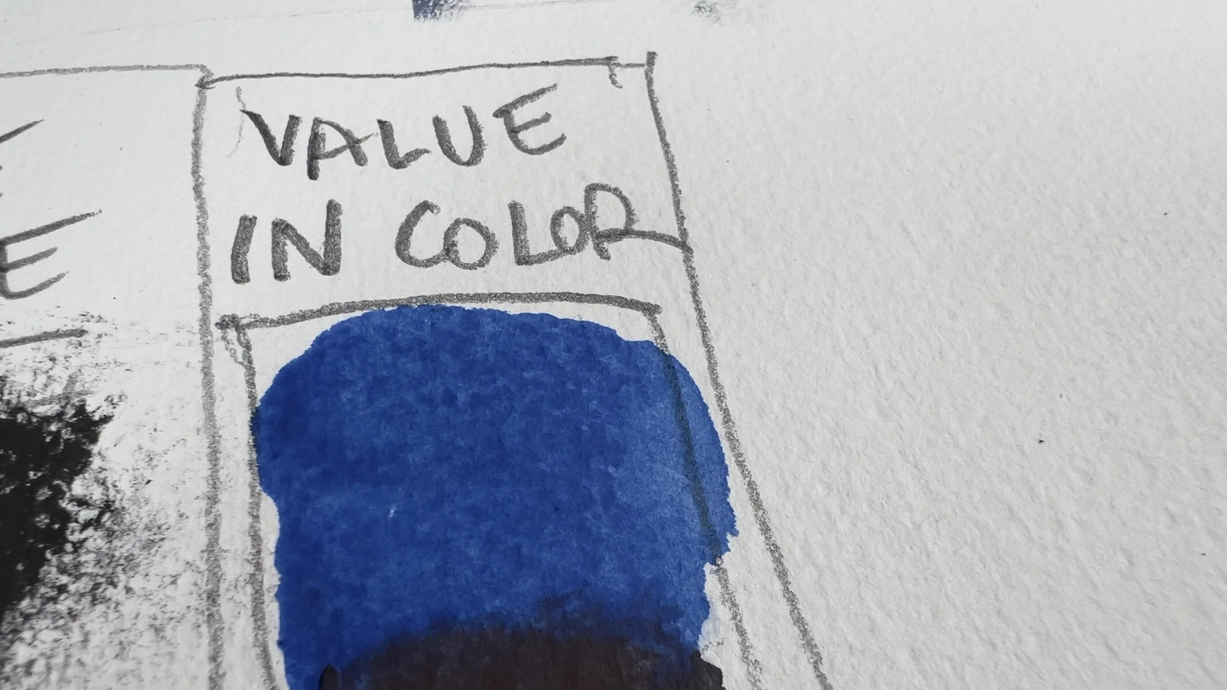 A hand-drawn sketch with the words "VALUE IN COLOR" written at the top, featuring a large blue circle or shape shaded with blue marker, on textured white paper.