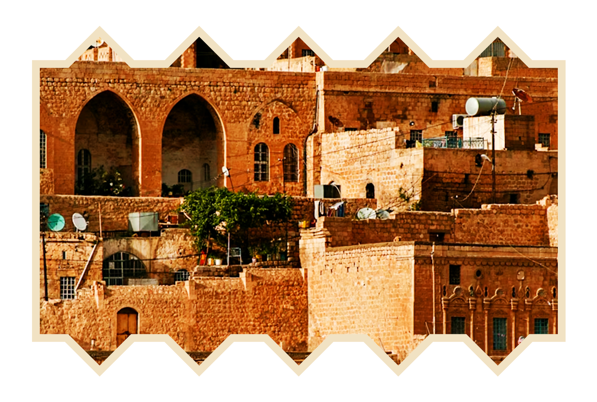 Close-up of a densely packed brick apartment building with arched windows and satellite dishes, set against a black background with a beige border.