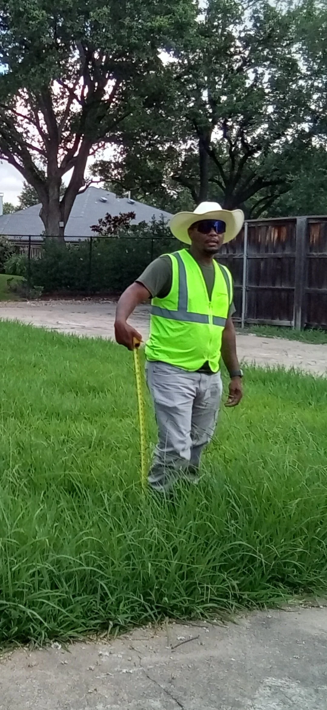 Director of Field Operations performing fence-line and vegetation assessment during property maintenance service in Collin County, Texas