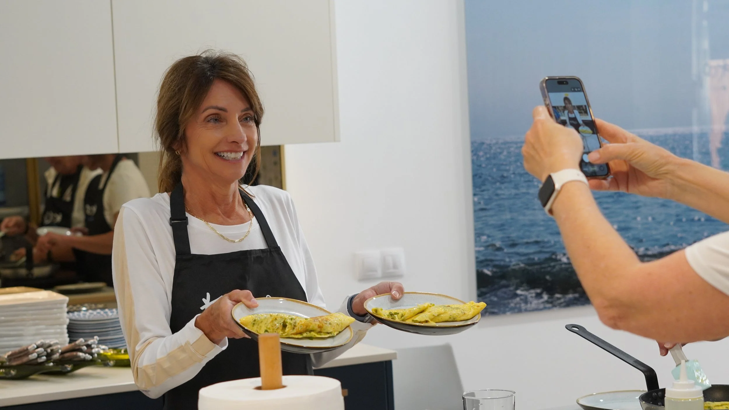 Guest presenting two freshly cooked omelettes during a Basque cooking class in San Sebastián