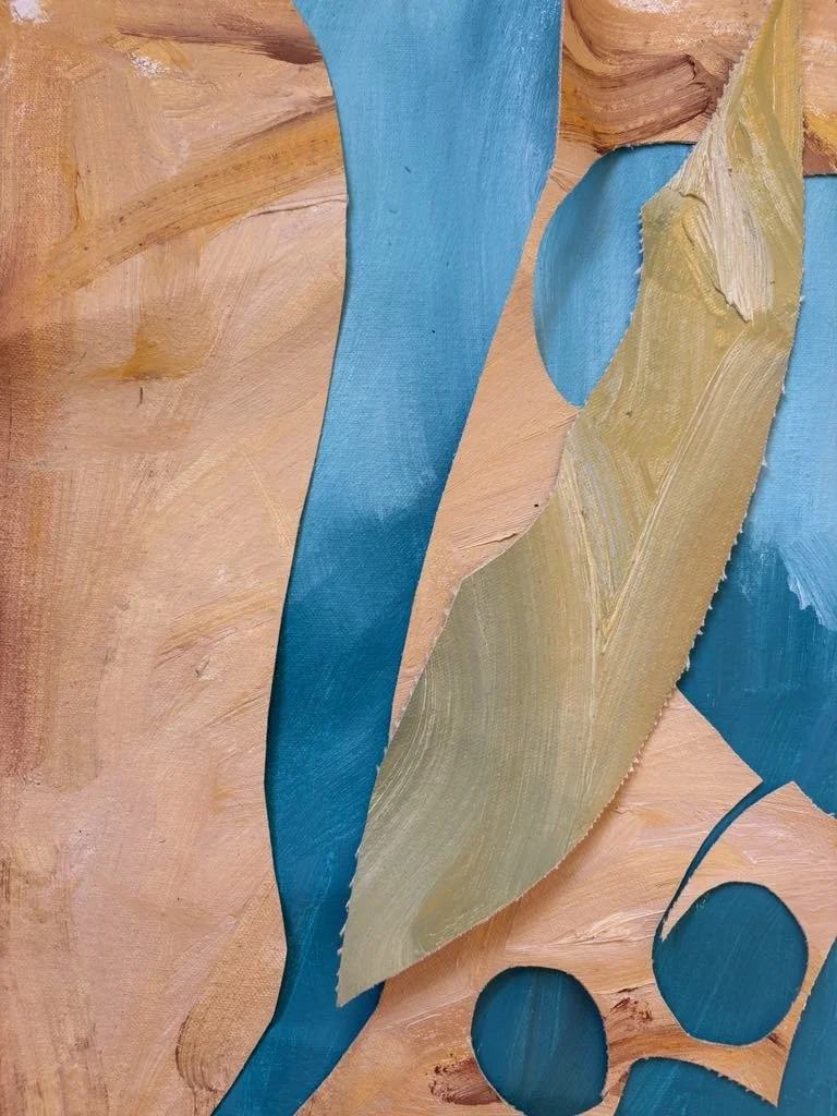 Close-up of an abstract painting with large blue and tan brushstrokes on a peach-colored background.