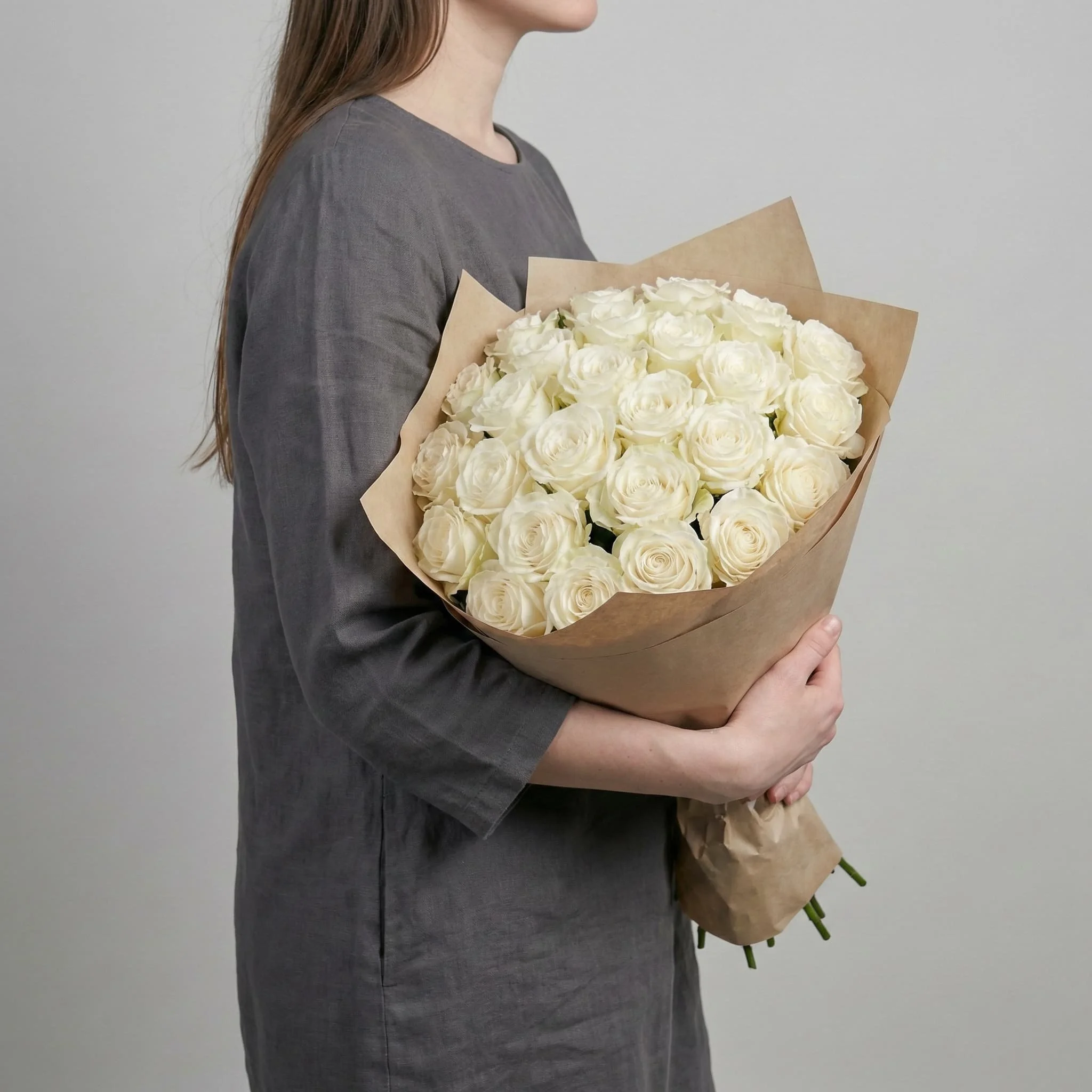 Minimal white rose bouquet held by florist at HORA Flowers in Perth