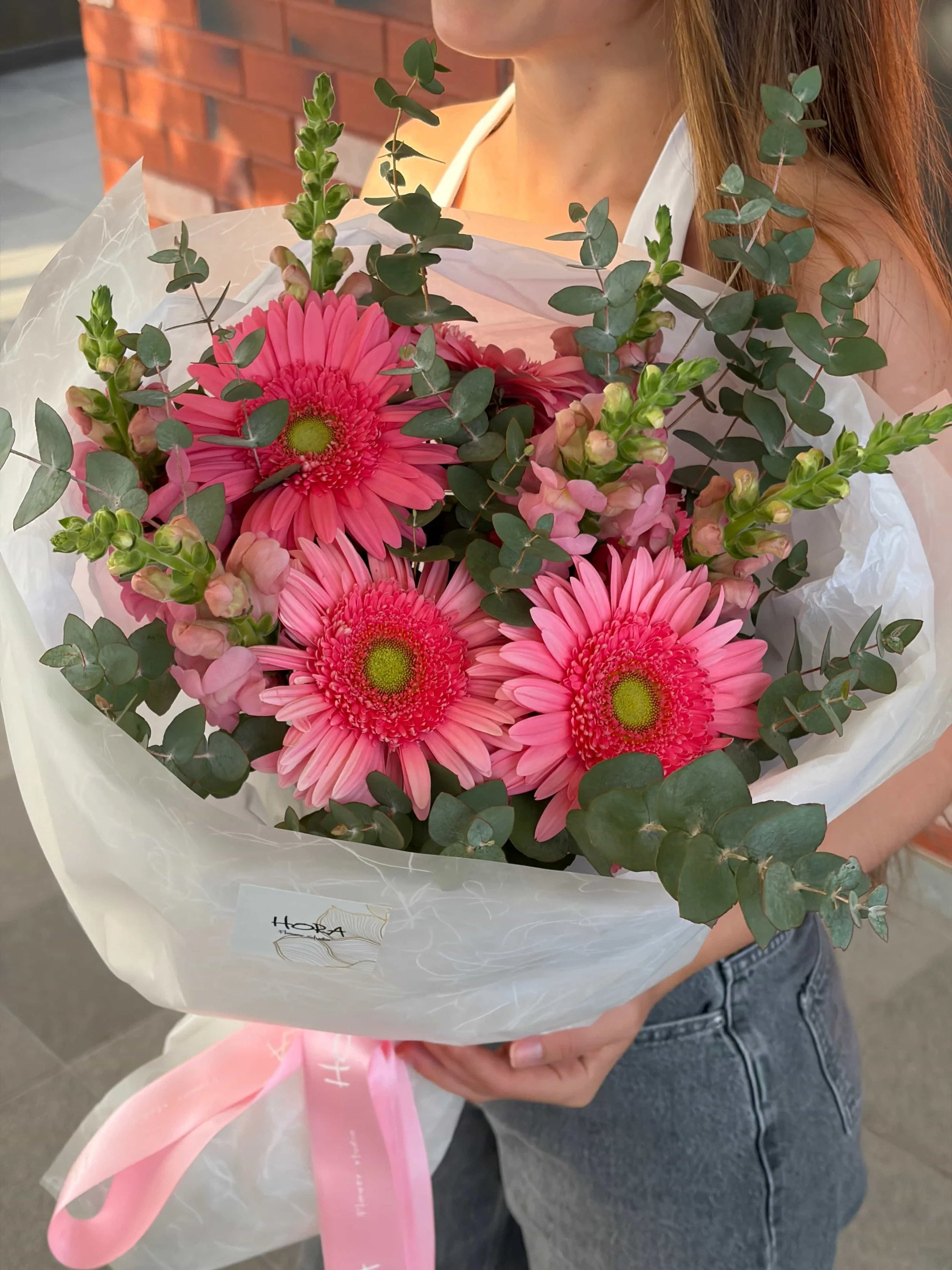 Detailed view of a wrapped pink garden bouquet with gerberas, eucalyptus greenery, and soft seasonal flowers by HORA Flowers Perth.
