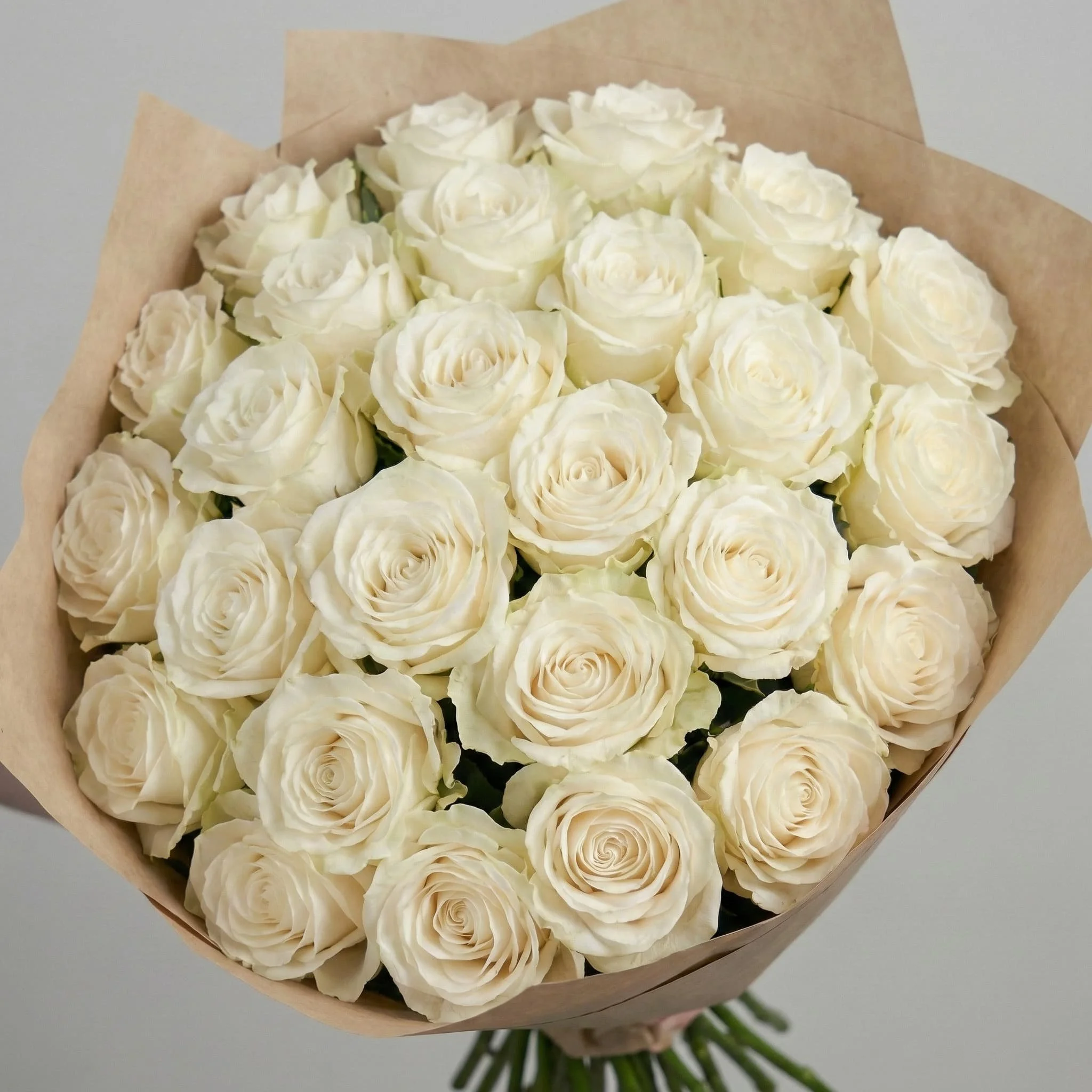 Modern white rose bouquet wrapped in kraft paper by HORA Flowers Perth