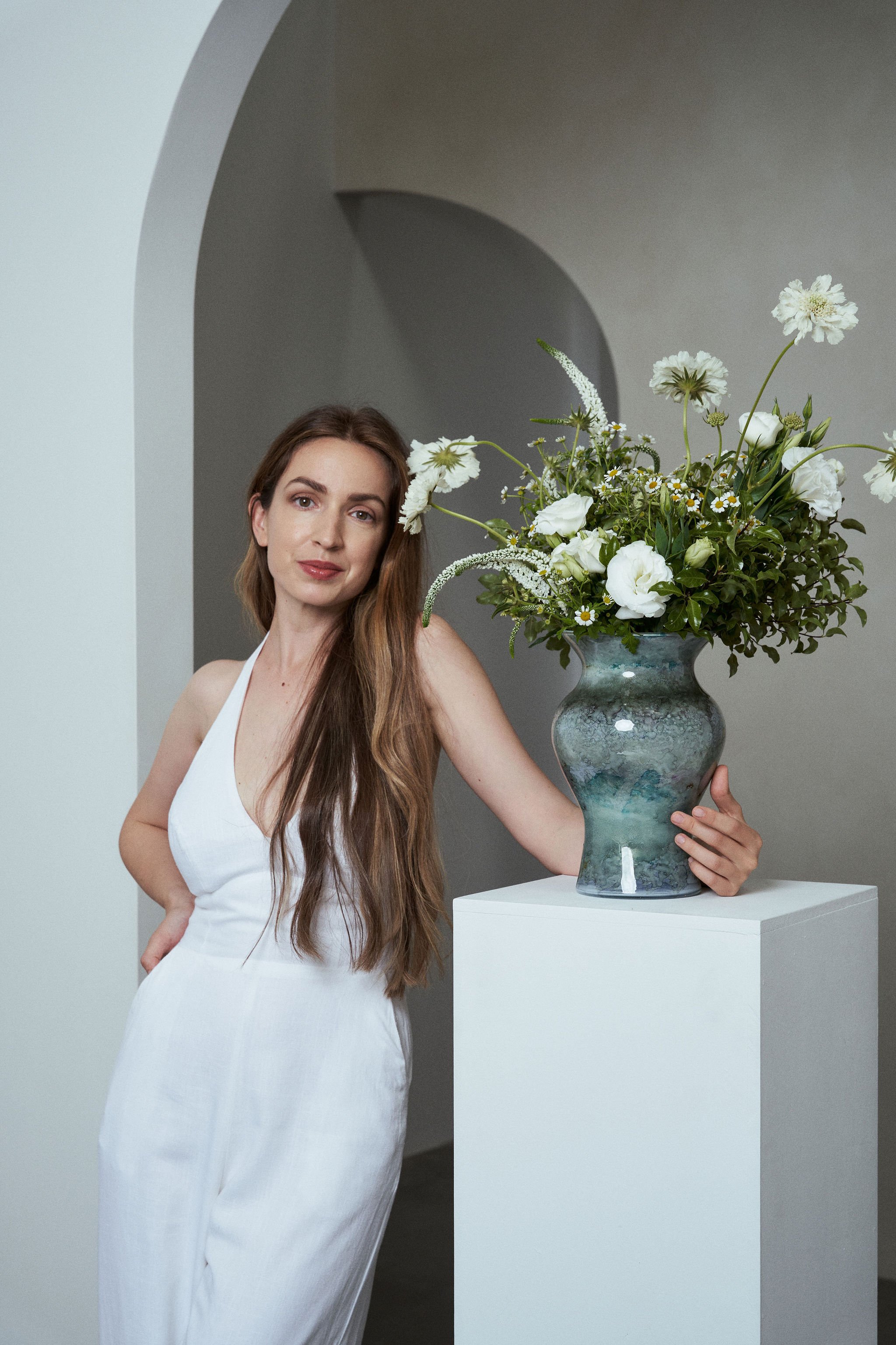 HORA Flowers white vase arrangement with seasonal blooms styled in a minimal interior