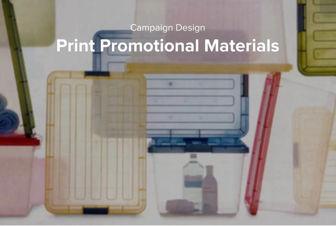 Colorful plastic storage containers placed on a surface, some open and some closed, with a yellow ruler and neatly rolled towels visible in the background, and text overlay reading 'Campaign Design Print Promotional Materials'.