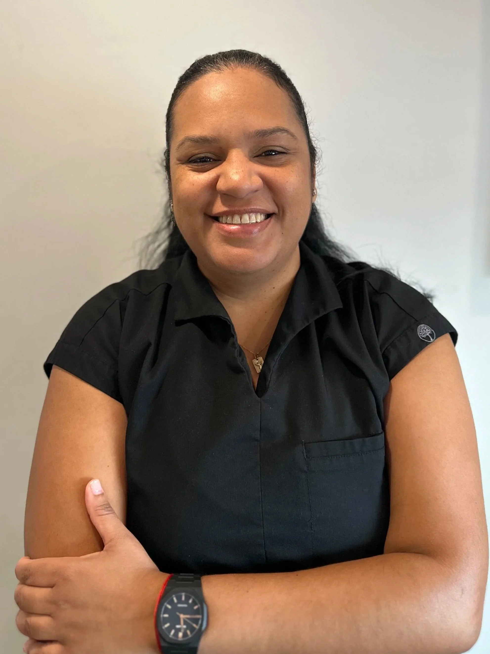 Close-up of a woman's smiling mouth showing white teeth and pink lipstick.