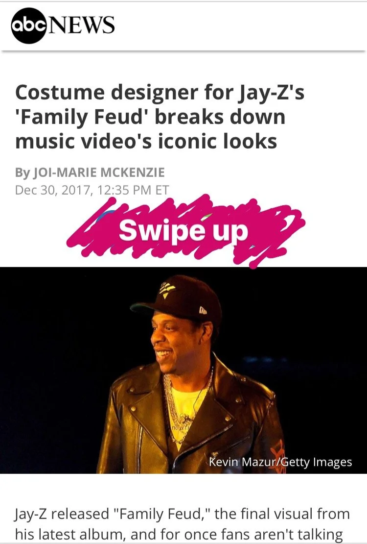 News article screenshot with a headline about costume designer for Jay-Z's 'Family Feud' music video breaking down iconic looks, dated December 30, 2017, featuring a photo of Jay-Z wearing a black leather jacket, a black cap with a logo, and gold cha