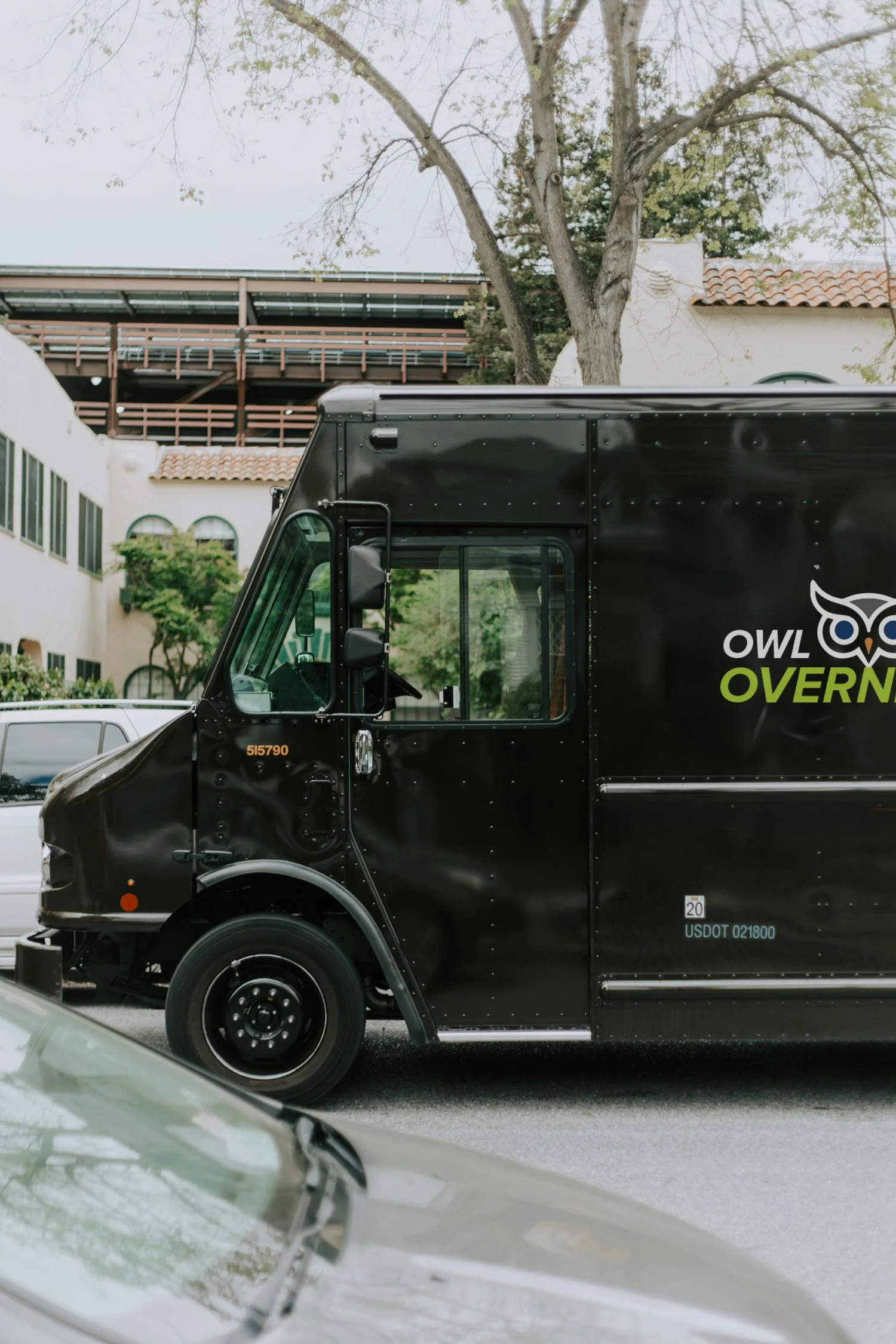 Owl overnight delivery truck parked on a street