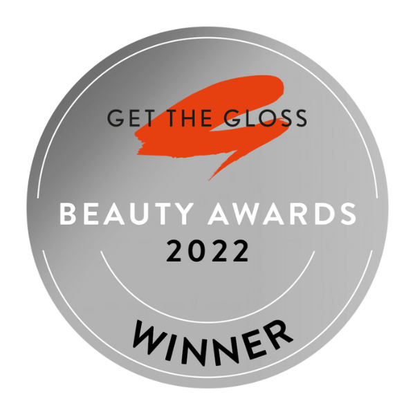 Silver circular badge with black, white, and orange text, indicating WINNER of the 2022 GET THE GLOSS Beauty Awards.