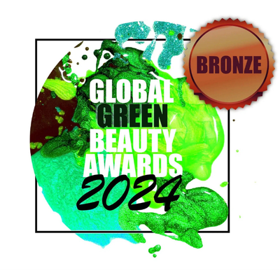 Graphic for the Global Green Beauty Awards 2024 featuring green and blue paint splashes, a bronze badge indicating bronze award, and text in bold white and black reading "Global Green Beauty Awards 2024."