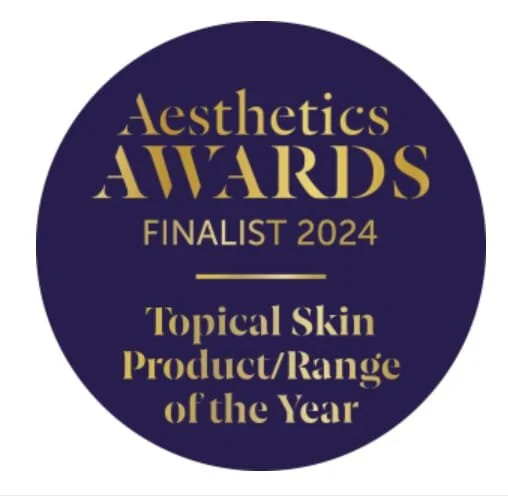 A round logo with a dark blue background and gold text, stating 'Aesthetics Awards Finalist 2024,' and 'Topical Skin Product/Range of the Year.'