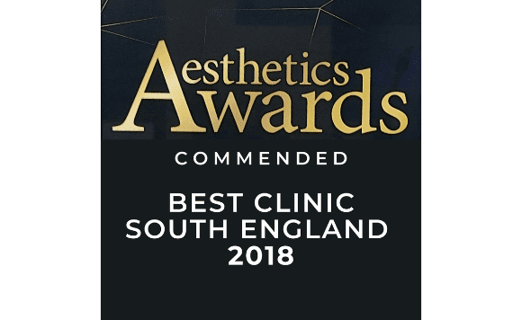 A certificate or award plaque indicating the 'Aesthetics Awards' for 'Best Clinic South England 2018,' with a gold and black color scheme.