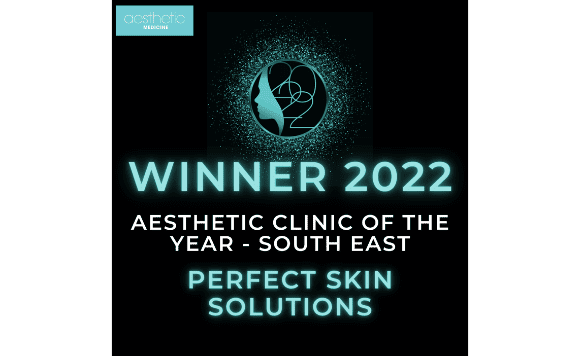 Award announcement for the 2022 Aesthetic Clinic of the Year - South East by Perfect Skin Solutions, featuring a logo with a profile of a face and a globe, with a digital splatter background.