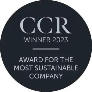 Black circular badge with silver text that says 'CCR WINNER 2023 AWARD FOR THE MOST SUSTAINABLE COMPANY'.