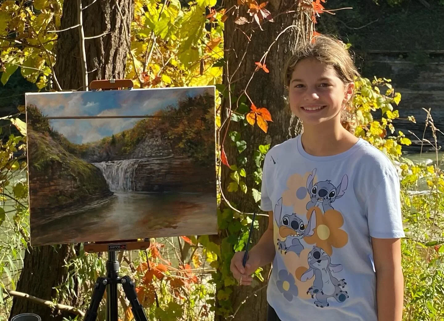 I just met Allie (not sure of her name spelling) and she helped me by painting on this fall painting of Upper Falls Letchworth St Park NY. I love to have young people try the experience of oil painting, (right on my painting) with the hope that it&rs