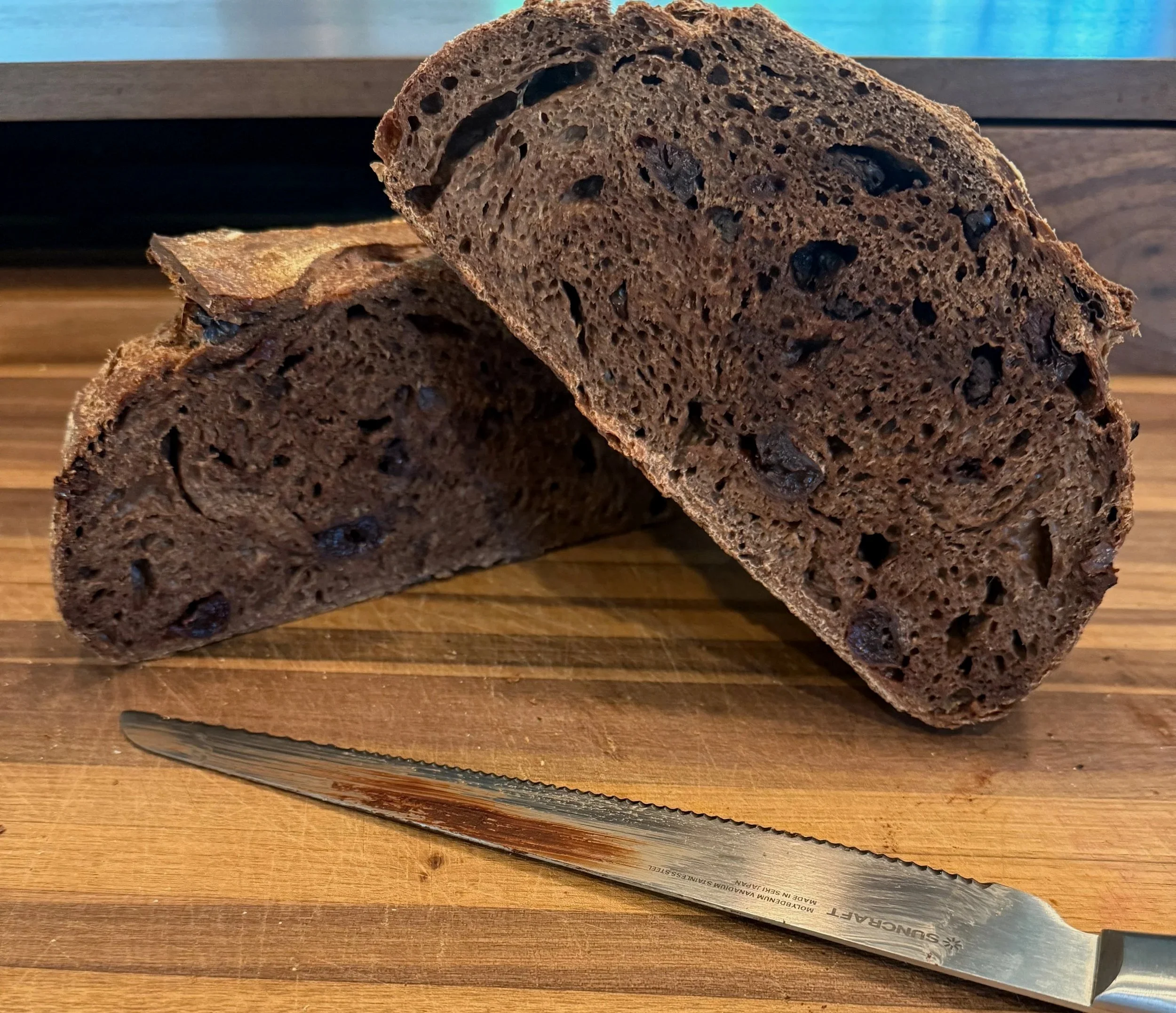  DARK CHOCOLATE CHERRY SOURDOUGH 
 
Dark Chocolate Cherry Sourdough is a decadent twist on tradition—rich, aromatic, and deeply satisfying. Made with two types of premium chocolate and generous amounts of dried sweet-tart cherries, this naturally lea