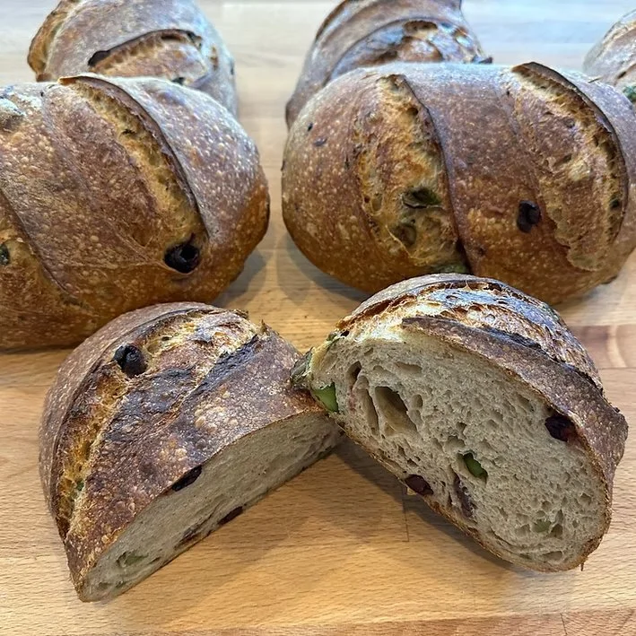  Kalamata Olive Sourdough  Kalamata Olive Sourdough with Herbes de Provence is a rustic, aromatic loaf that brings a taste of the Mediterranean to your table. Briny Kalamata olives are folded into a naturally leavened dough infused with a fragrant bl