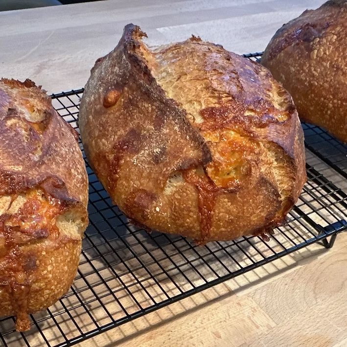  Pain au Fromage  Pain au Fromage is a savory sourdough masterpiece that marries the nutty richness of Gruyère cheese with the fragrant freshness of rosemary. Naturally leavened and slowly fermented for depth of flavor, this loaf bakes to a golden, b