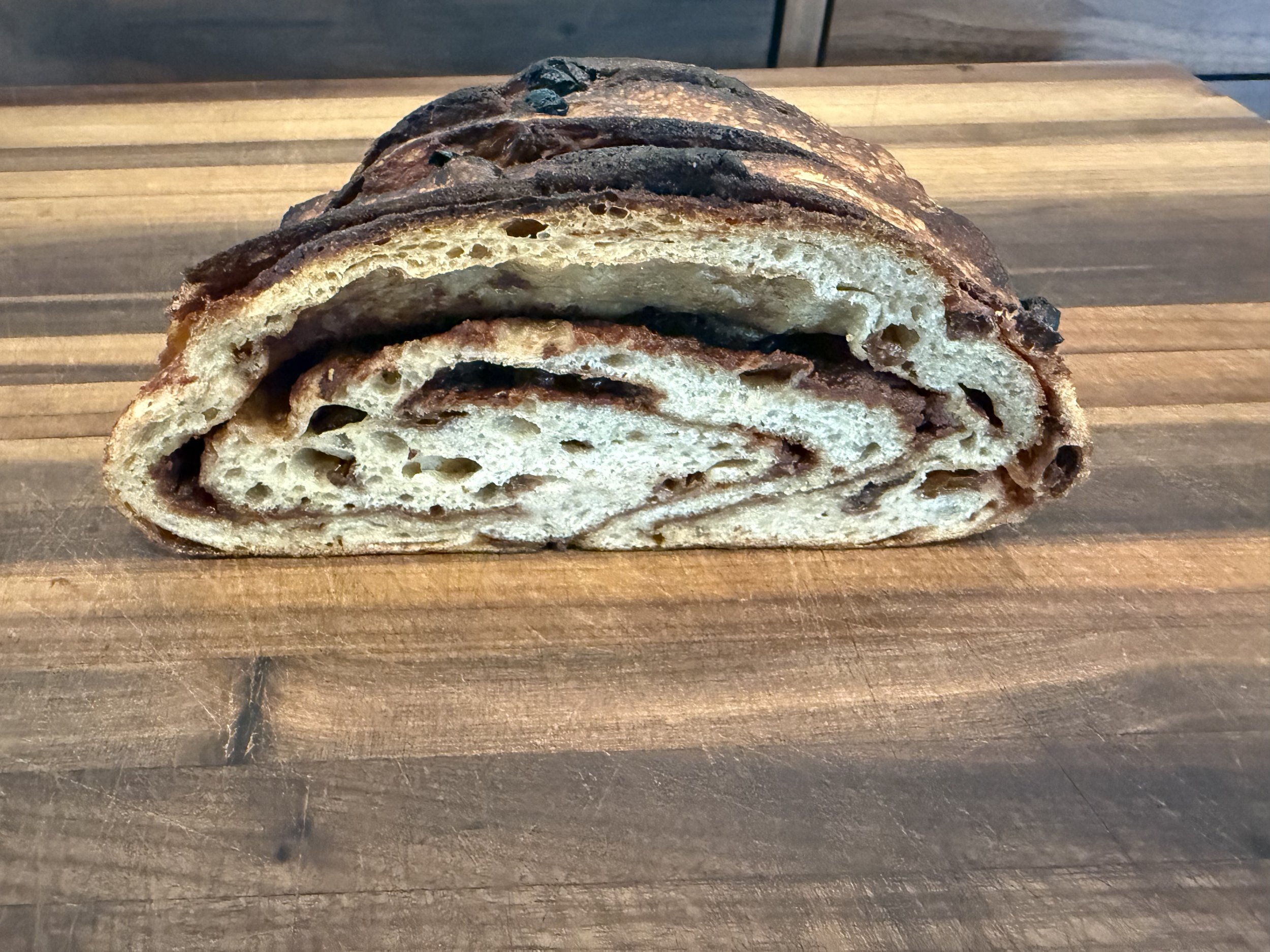  Cinnamon Raisin Sourdough  Cinnamon Raisin Sourdough is a warm, comforting loaf that blends the gentle tang of natural fermentation with the sweetness of plump raisins and aromatic cinnamon. Each slice reveals a tender, beautifully swirled crumb wit