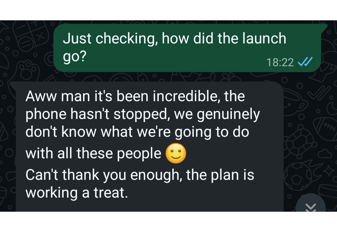 Screenshot of a WhatsApp chat conversation with green and gray message bubbles, discussing the success of a phone launch.