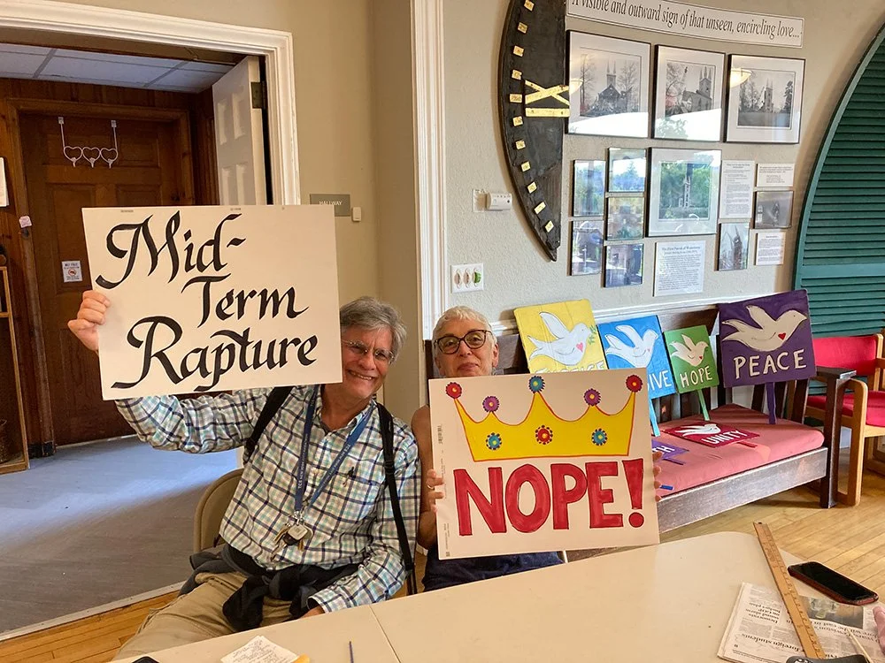 Two Watertown residents holding no kings signs they created