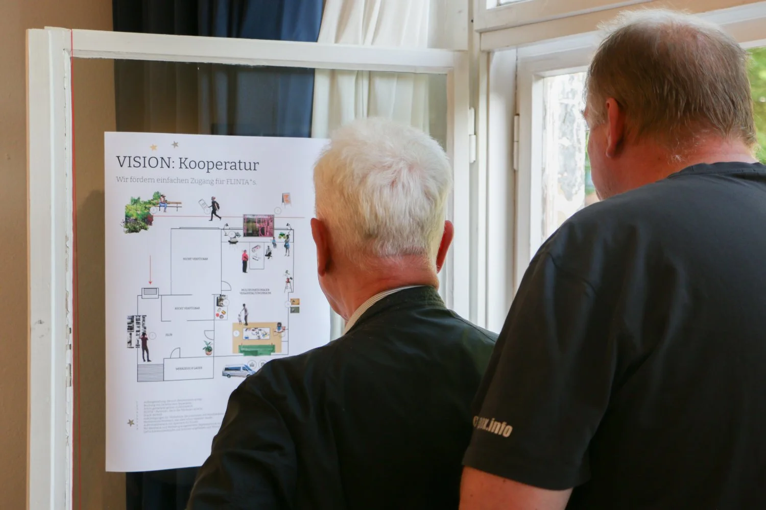 Two older people looking at a poster