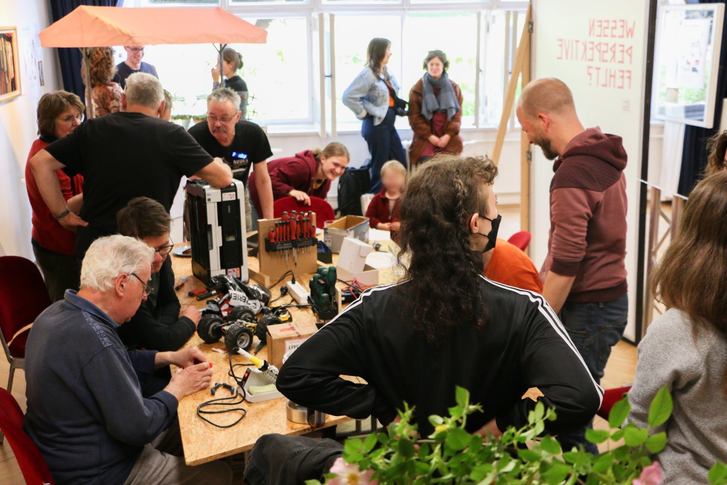 People repairing electronics on a table