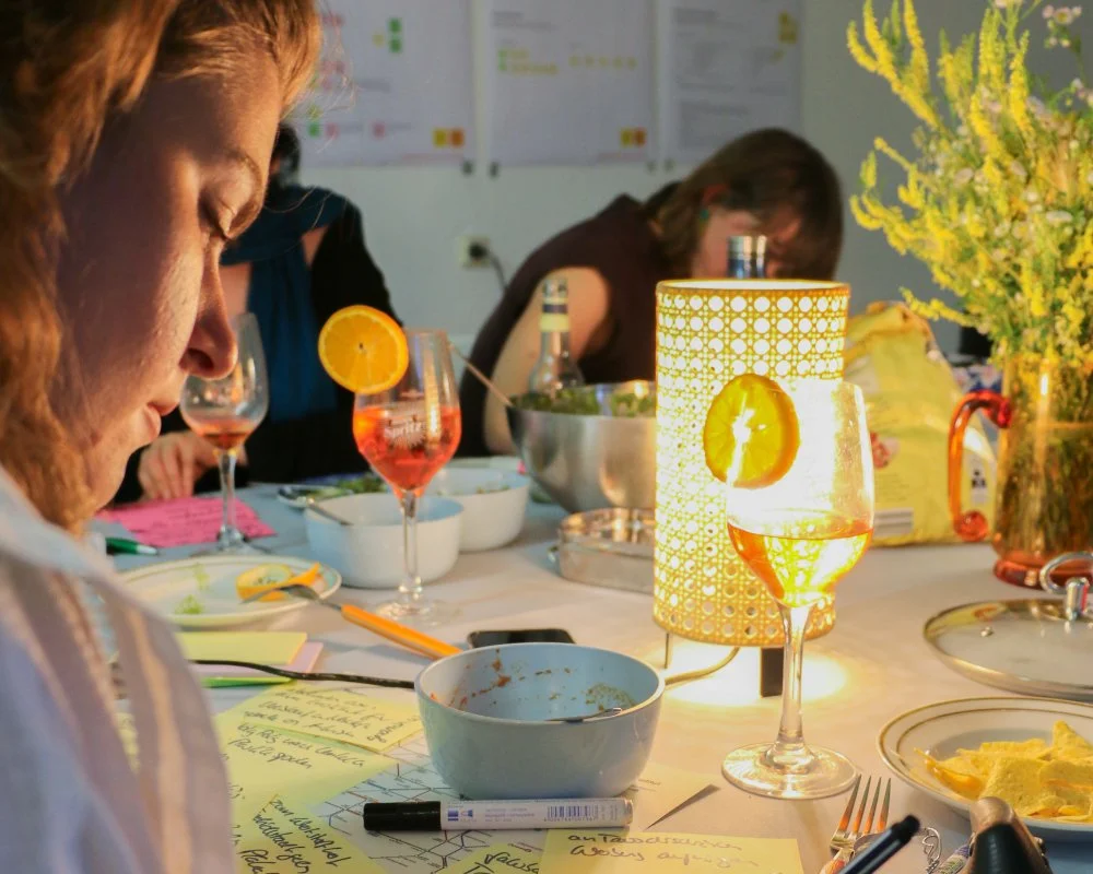 Close-up of a person writing down on a sticky note on a dinner table