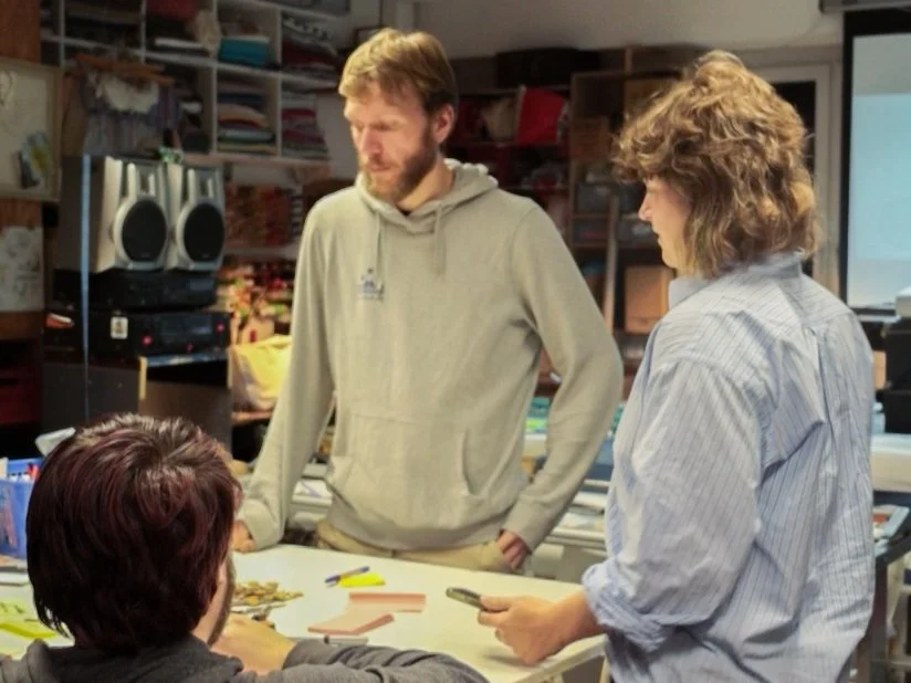 Three people on a table with sticky notes