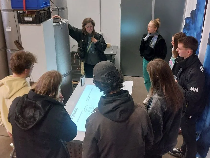 Overhead shot of people around a projected map on a table