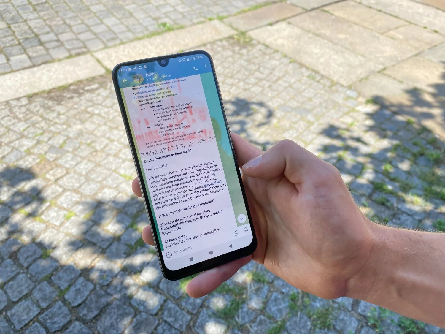 Interview invitation displayed on phone held by a person