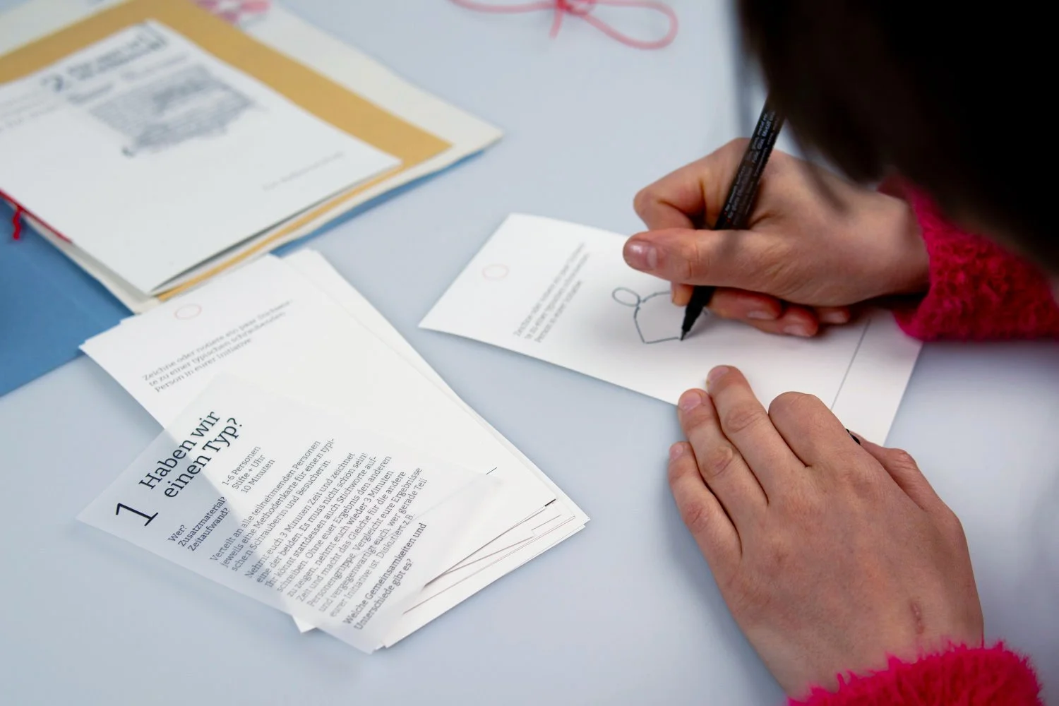 Person drawing on worksheet