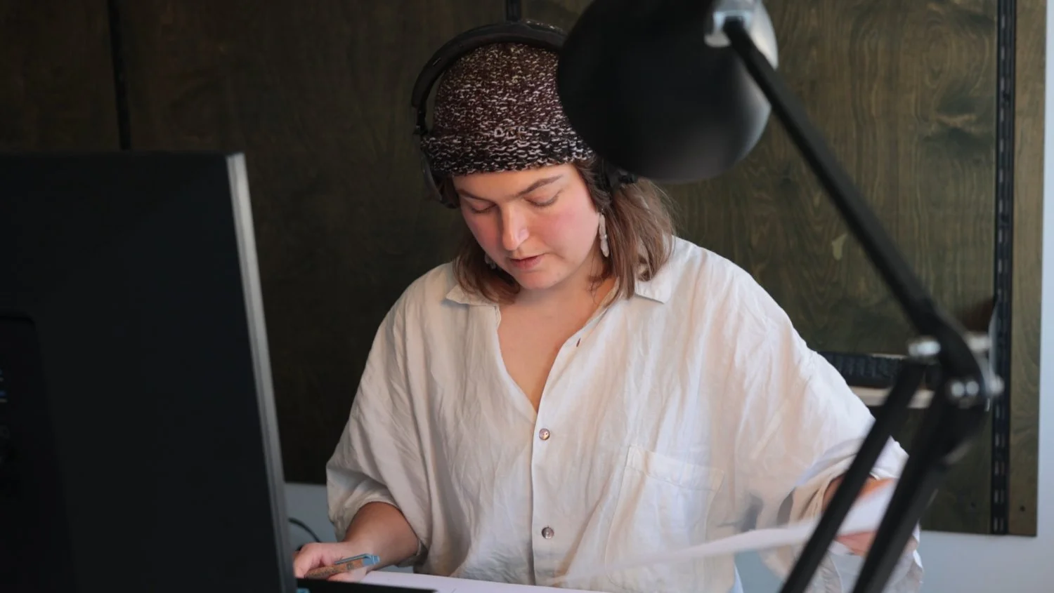 Interviewer sitting at a pc looking through notes