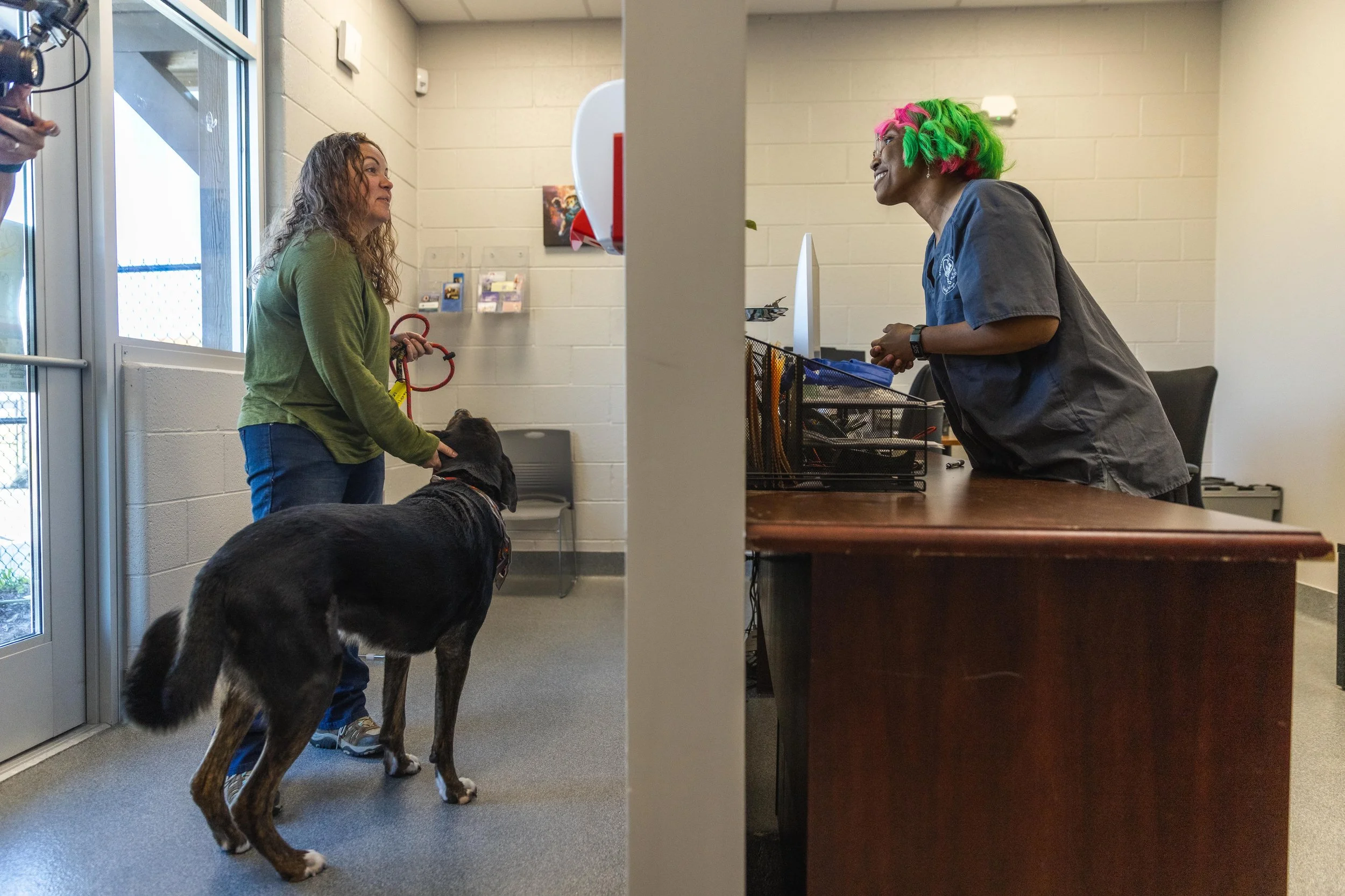 Women bringing in a dog to Sevier County Animal Shelter and an employee greeting them. Lost & Found pets in Sevier County, TN.