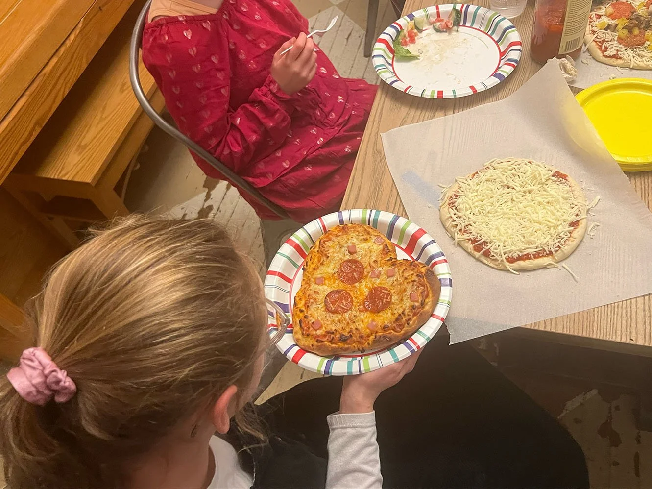 Avi and her heart-shaped pizza.