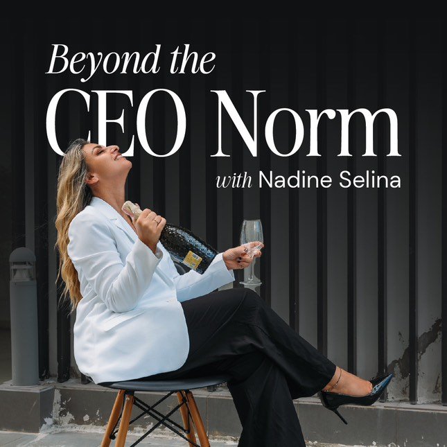 Woman in white blazer and black pants sitting on chair with champagne, smiling, in front of black striped wall, with text 'Beyond the CEO Norm with Nadine Selina'