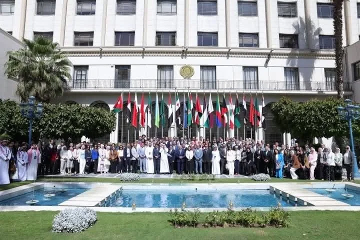 Participants gathered outside a building with international flags in Jordan