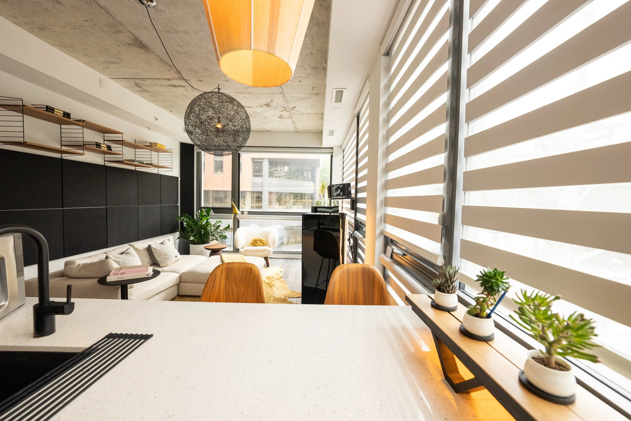 The view from the kitchen made cooking a pleasant experience. A fabric pendent was added over the eating area along with undermount lighting. 