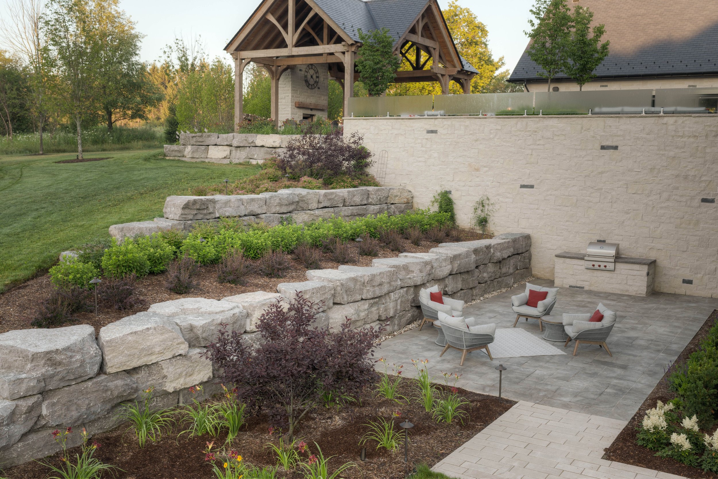 A massive retaining wall separates the upper terrace from the lower guest patio. With their own BBQ guests who visit for longer stays can enjoy some privacy and the formal gardens provide a beautiful visual from inside. 