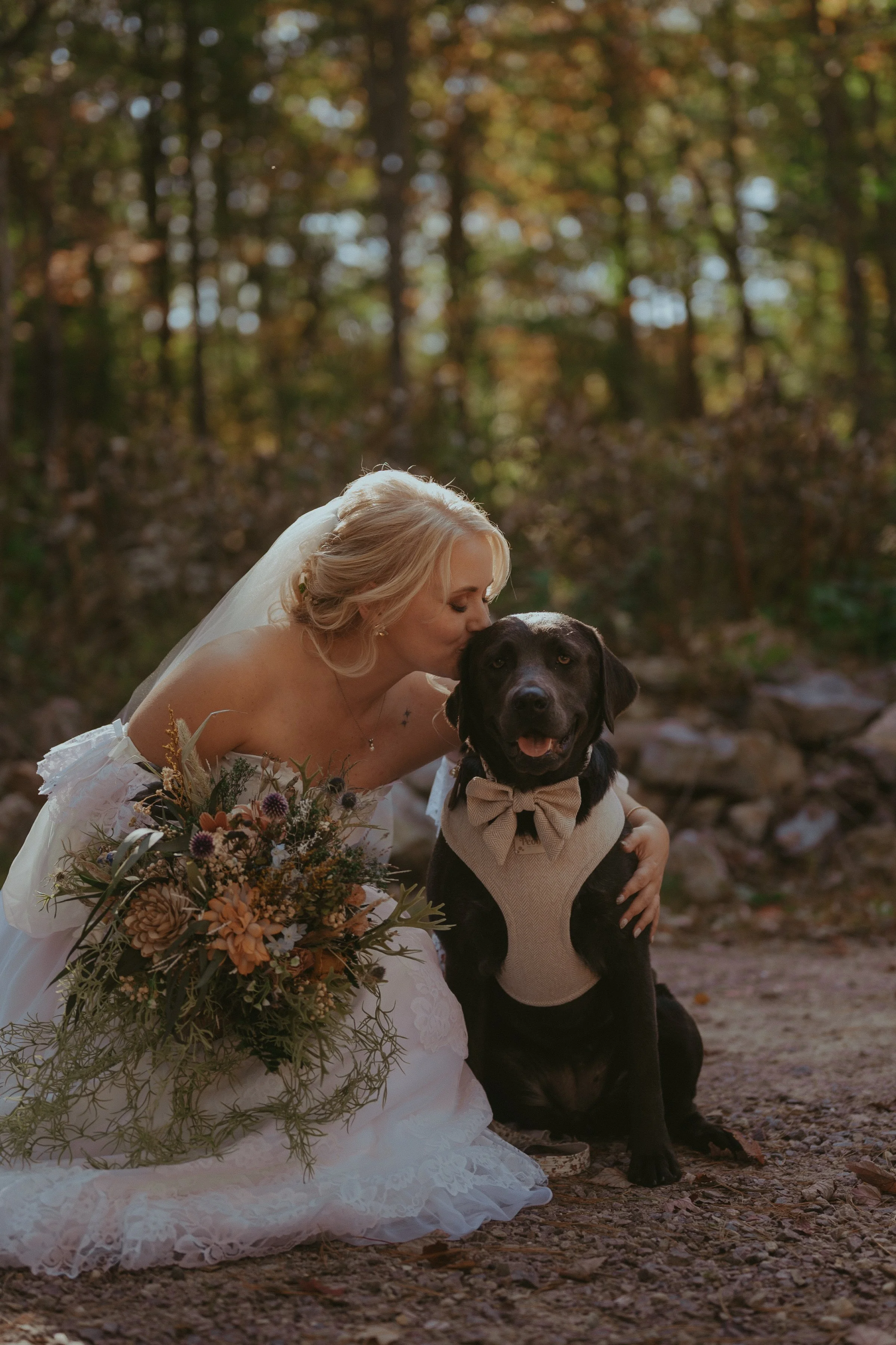 Bride sharing a kiss with their dog during Wisconsin wedding portraits.