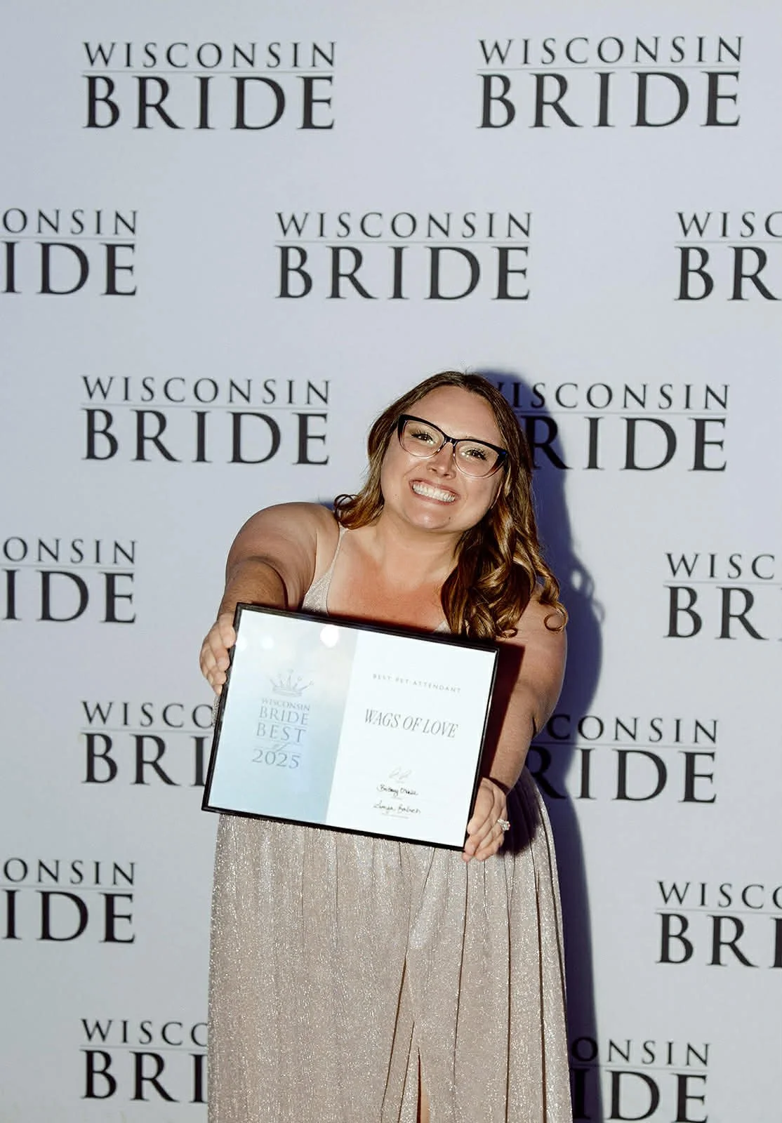 Wags of Love team holding Wisconsin Bride Best Pet Attendant award in Milwaukee