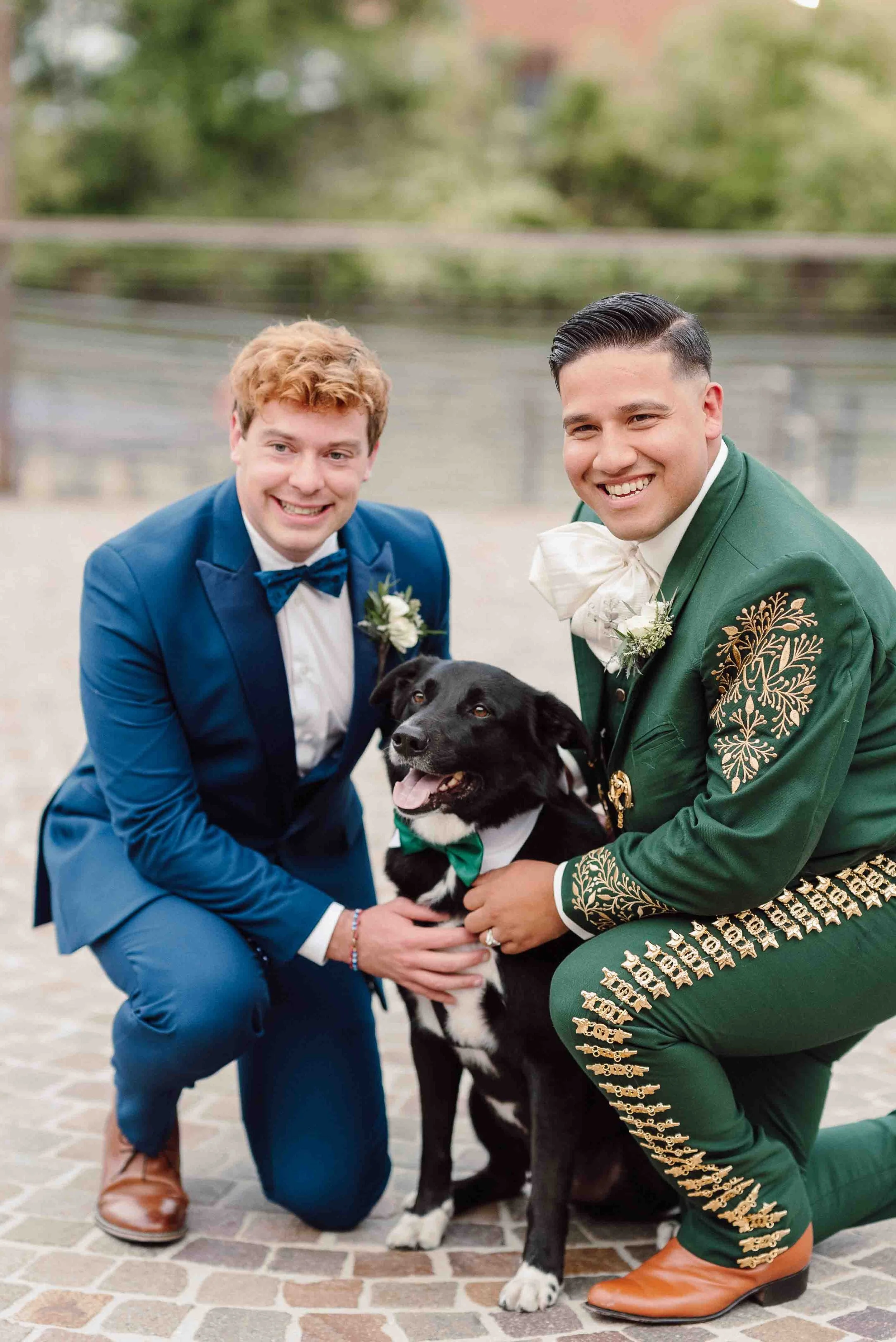 Two grooms posing with their dog during Chicago wedding portraits with professional pet wedding attendant.